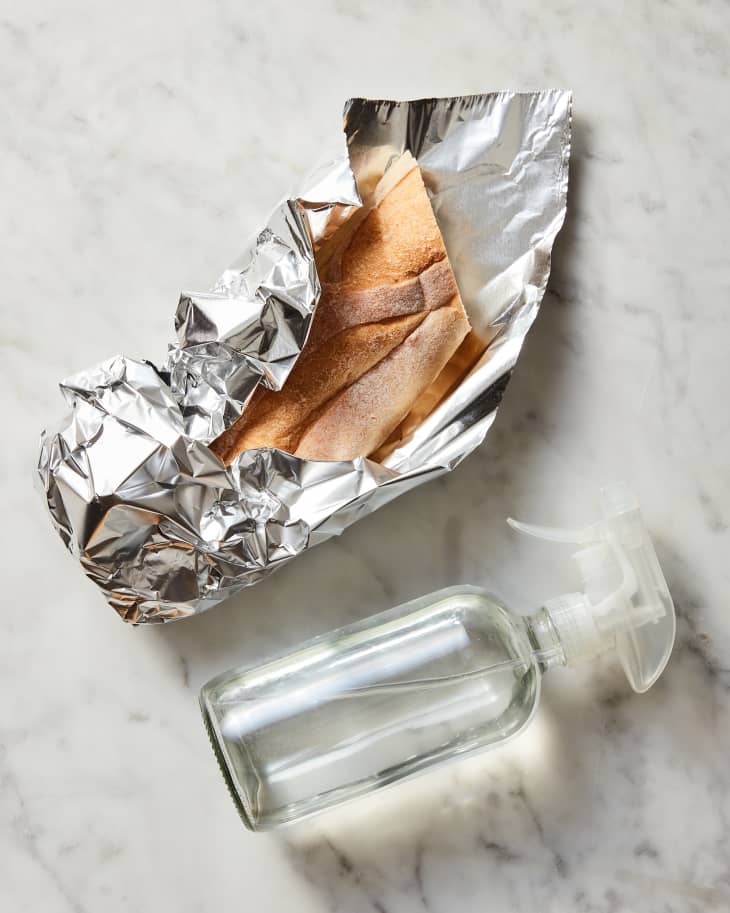 bread in tin foil with spray bottle