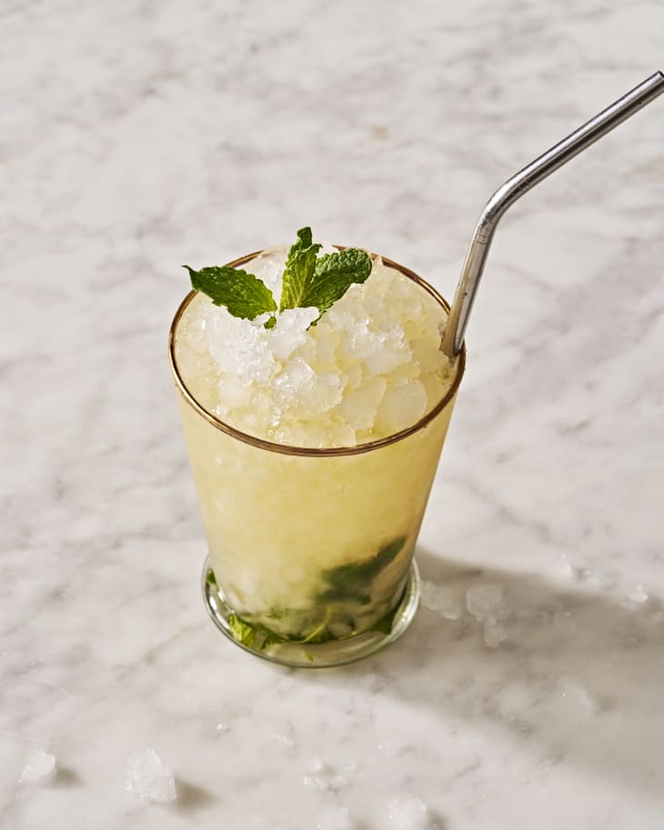 mint julep in a glass with mint on the bottom and top