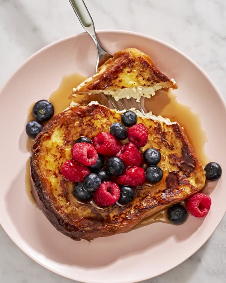 French toast on pink plate with berries