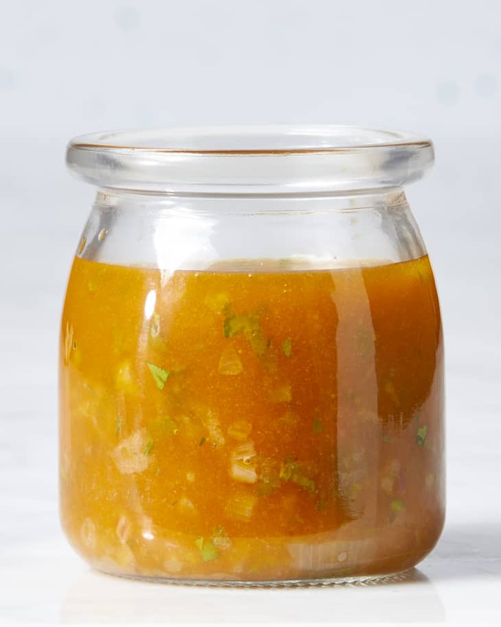 Front view of a jar filled with chorizo vinaigrette.