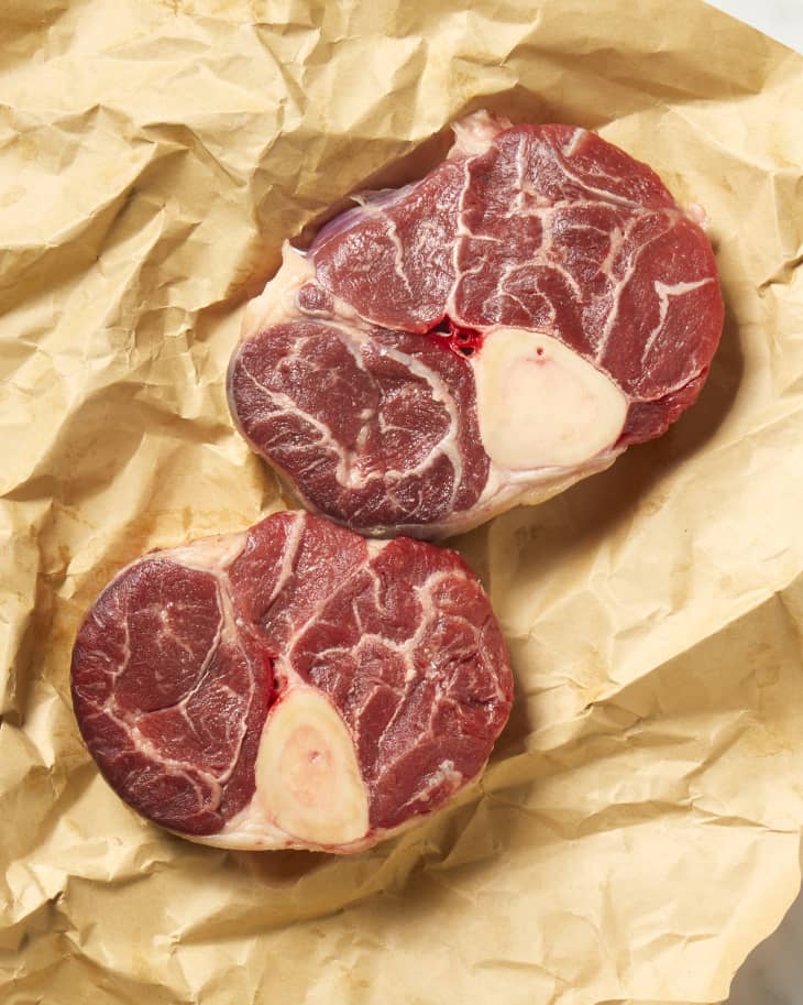 Overhead view of two cuts of beef shank on brown butcher paper.