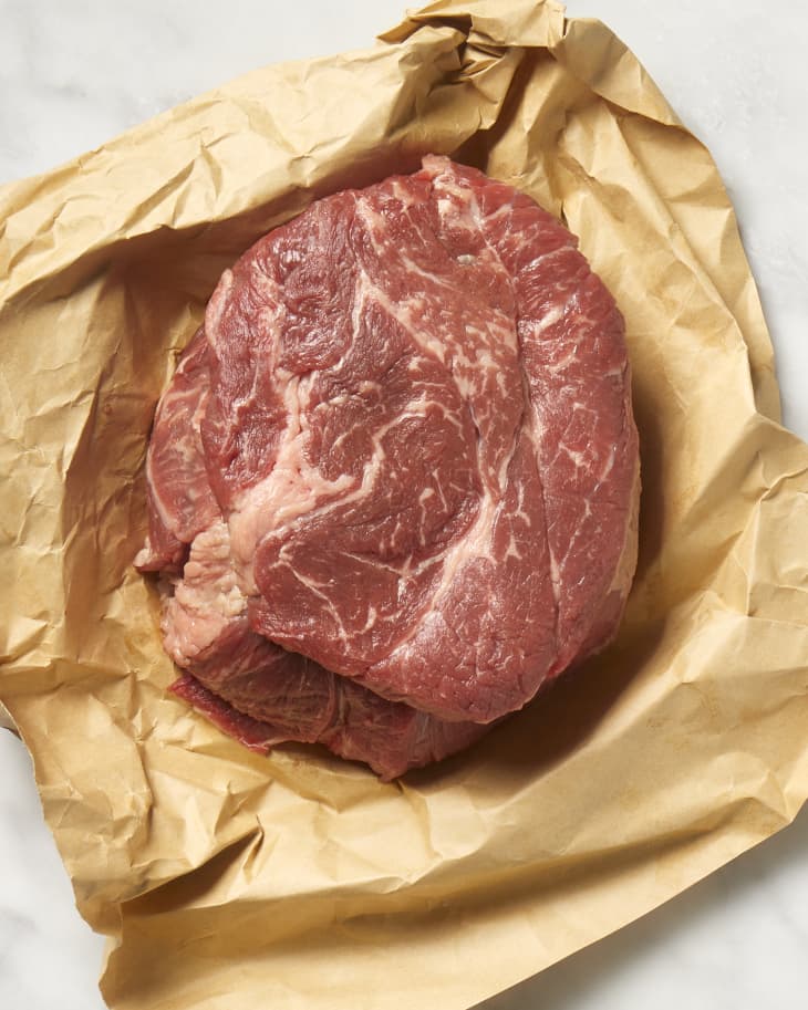 Overhead view of beef shoulder on brown butcher paper.