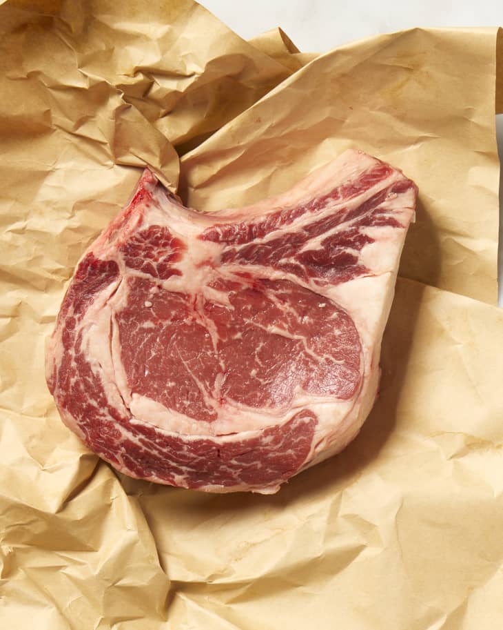 Overhead view of a cut of ribeye on brown butcher paper.