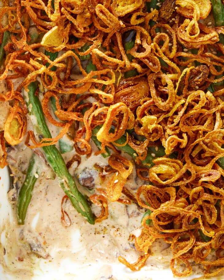 Closeup of a zaatar green bean casserole in a baking dish with some scooped out.