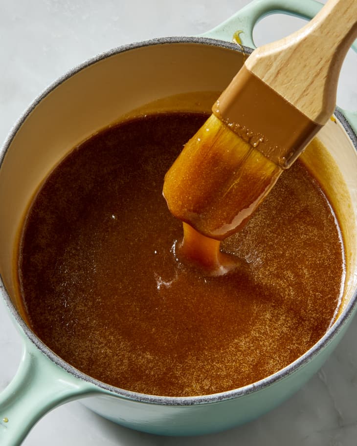 OVerhead shot of a pastry brush being dipped into the brown sugar glaze.