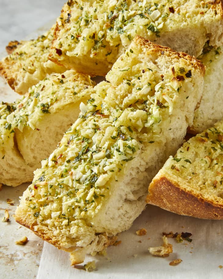 Head on shot of a messy stack of garlic bread slices.