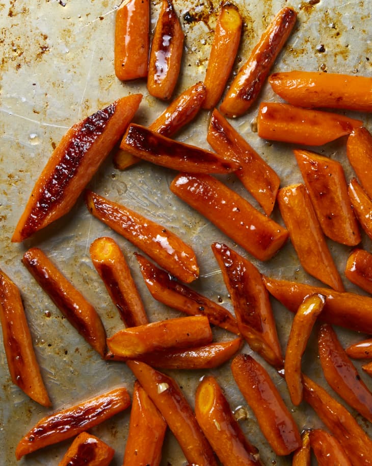 Overhead view of cooked carrots on a sheet pan.