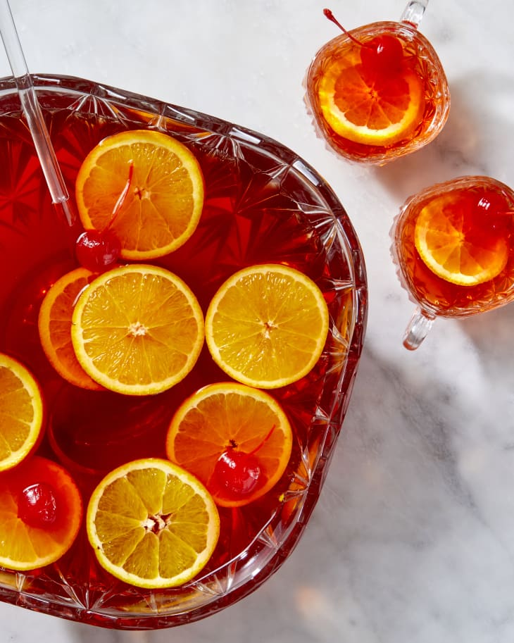Overhead shot of southern thanksgiving punch in a punch bowl, and two glasses to the right of the bowl.