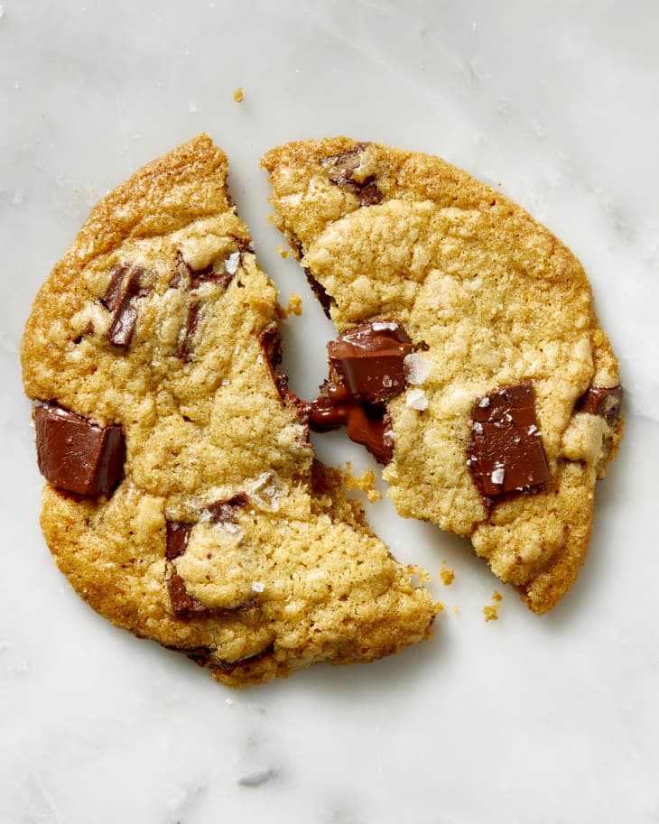 Overhead view of a single chocolate chip cookie broken in half.