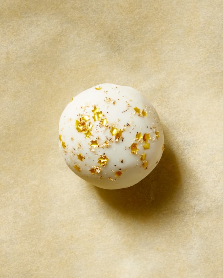 Overhead view of a single eggnog cookie truffle on brown butcher paper.