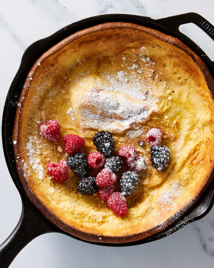 dutch baby with sugar and berries