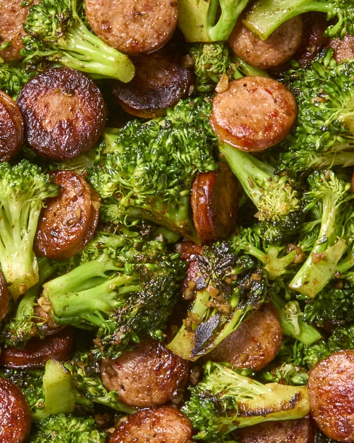 Sausage slices and broccoli sautéed with Cajun seasoning in a cast iron skillet.