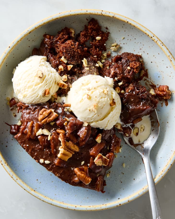 skillet cake in bowl with ice cream scoops