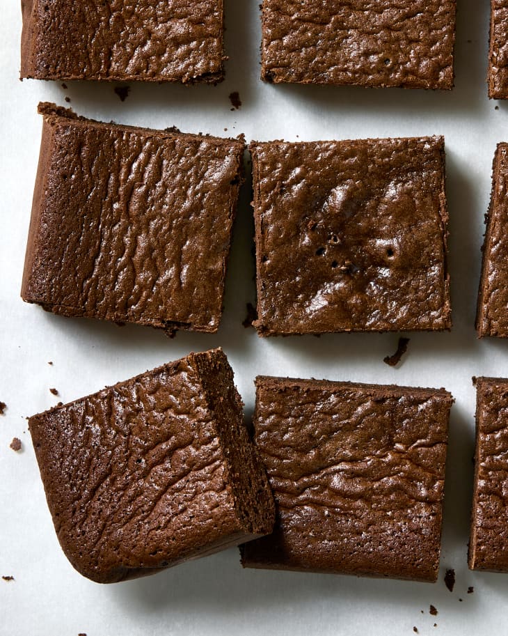 Overhead photo of cut brownies on parchment paper.