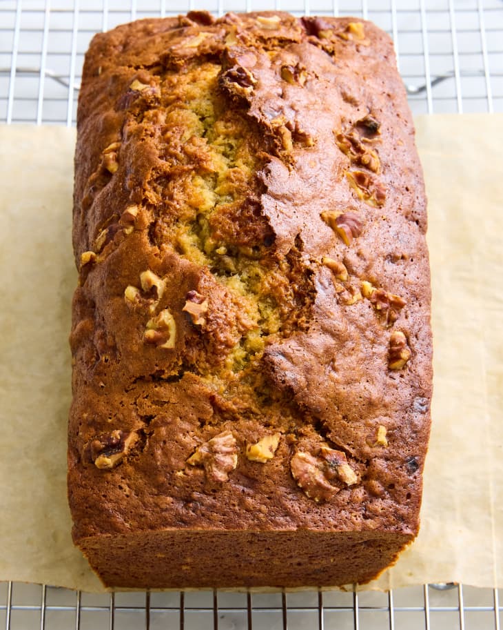 banana bread on brown parchment on wire rack