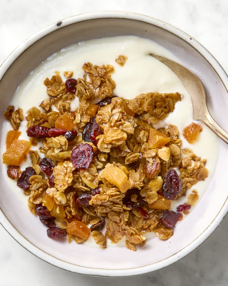 overhead shot of granola in a bowl with yogurt.