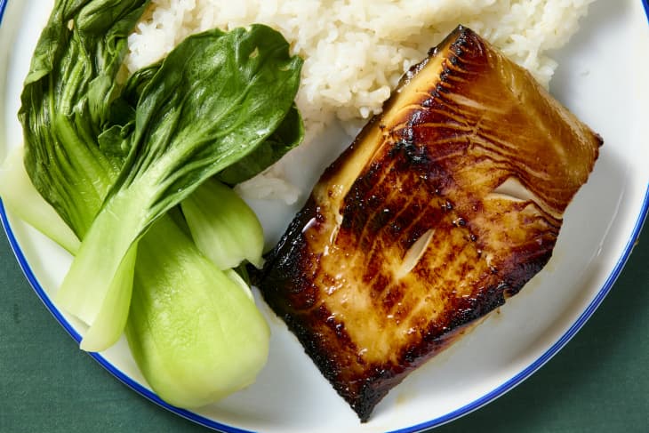 overhead shot of miso black cod on a plate with bok choy and white rice.