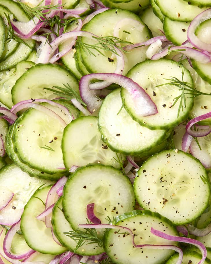close up shot of cucumber salad, topped with dill