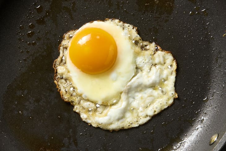 overhead shot of a fried egg being made in butter.