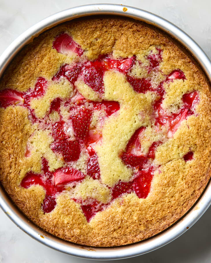 overhead shot of a full strawberry spoon cake in a cake pan