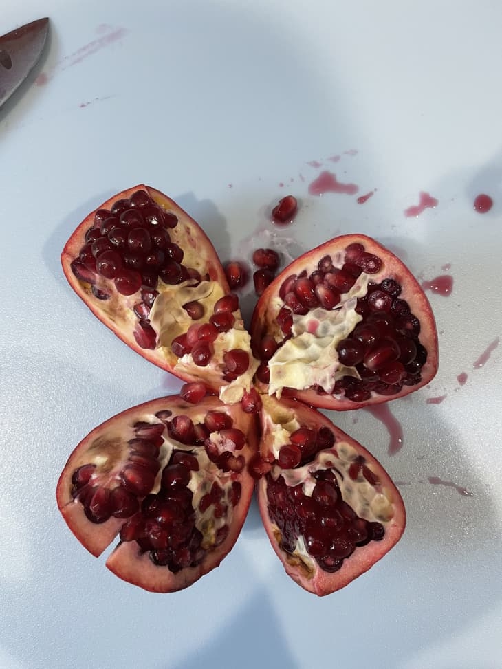 An open pomegranate on a white surface