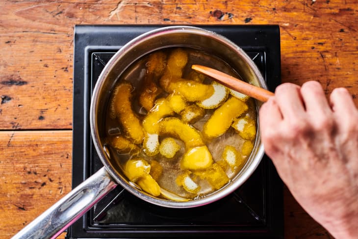 stirring strips of lemon zest in a saucepan with simple syrup