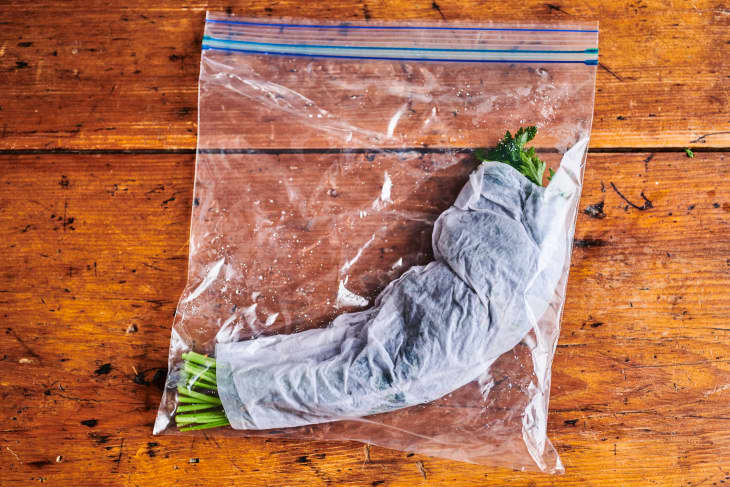 parsley rolled in paper towels like a cigar and in a large zip-top baggie, paper towels are damp