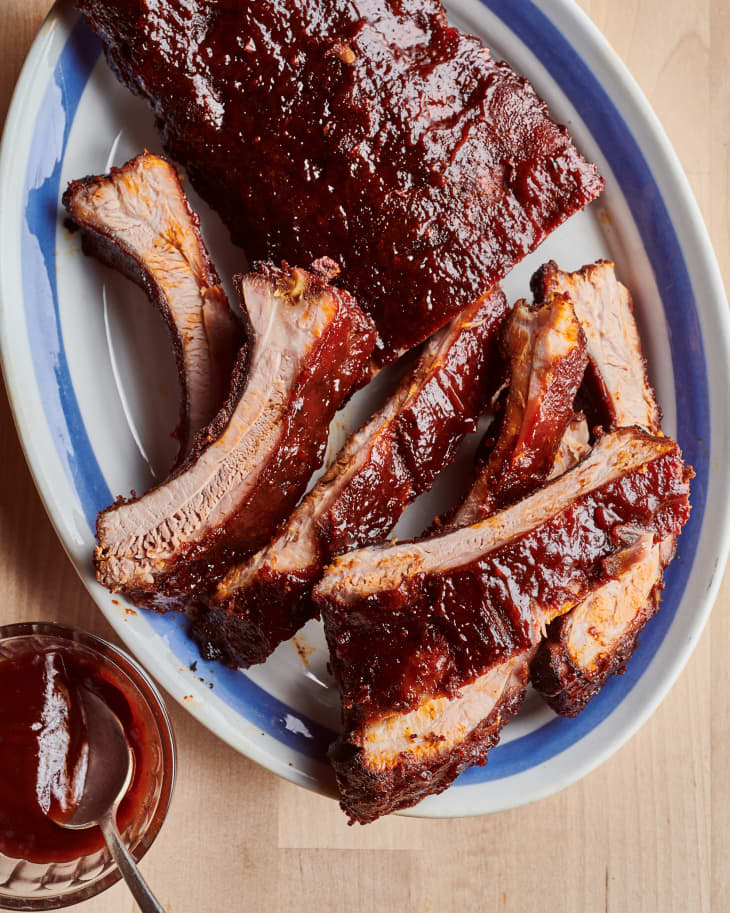 ribs on a platter with barbecue sauce