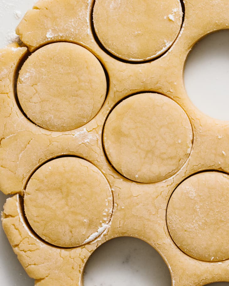 Shortbread cookie dough with cookie cutter cut outs.