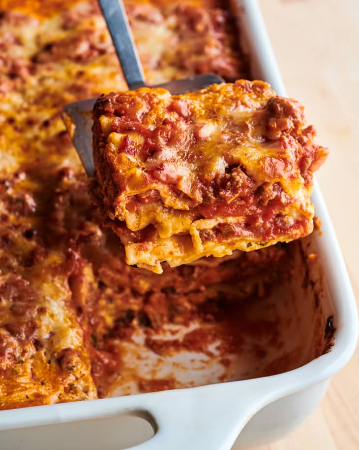Martha Stewart's lasagna with meat sauce sliced out on spatula.