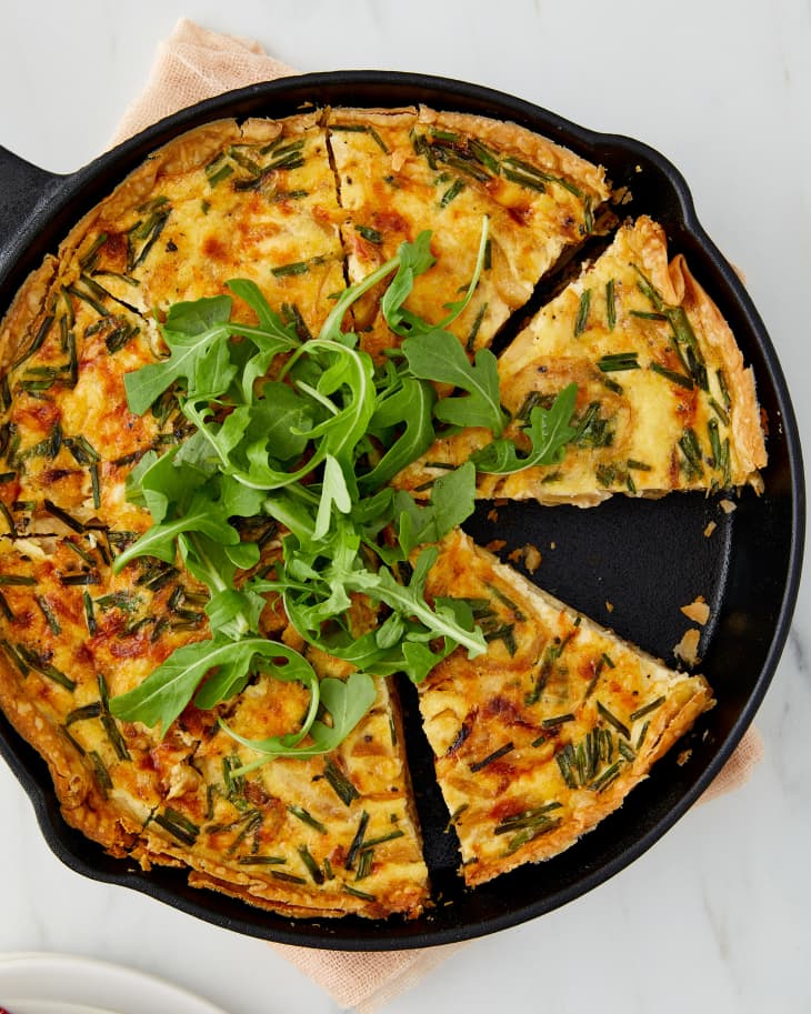 Caramelized onion quiche in skillet on countertop.
