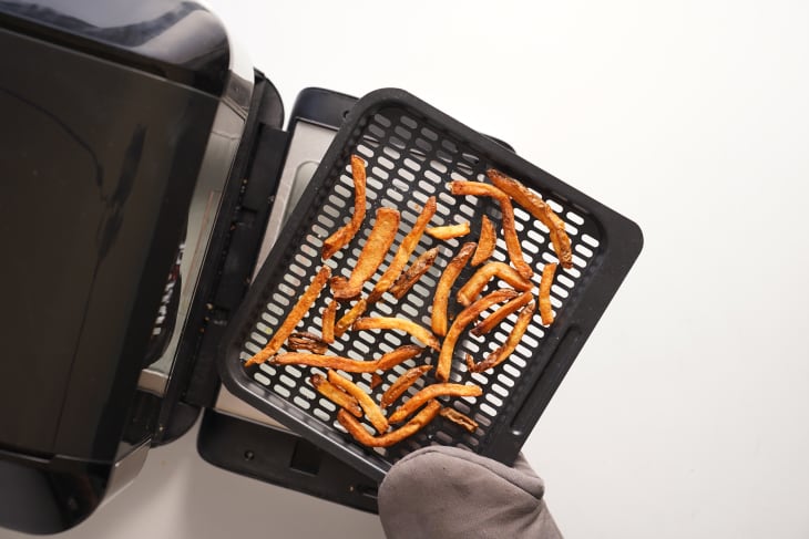 French fries coming out of air fryer.