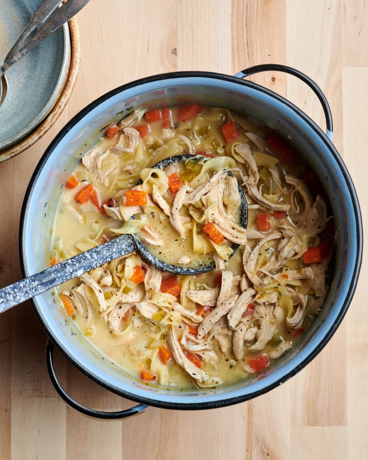 Creamy chicken noodle soup in large pot.