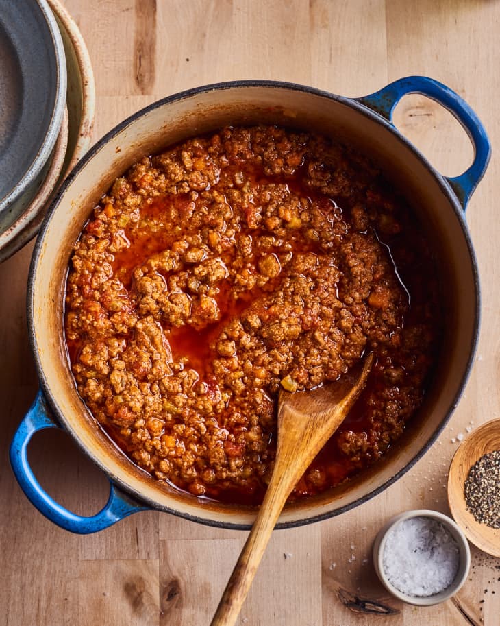 Marcella Hazan's bolognese sits in a blue pot with a spoon in it