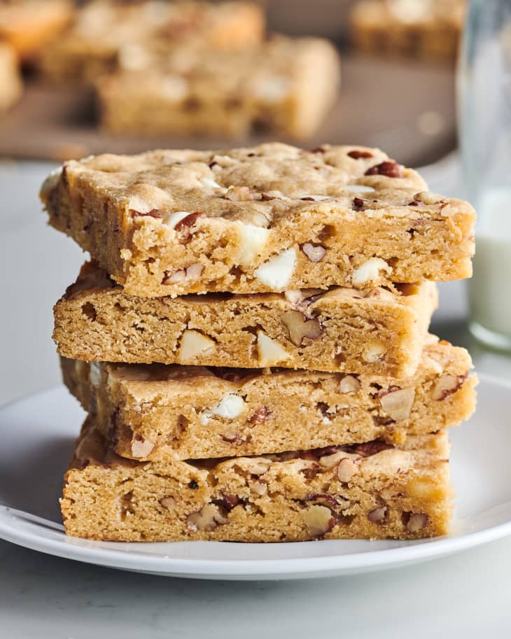four blondies sit on top of each other on a plate