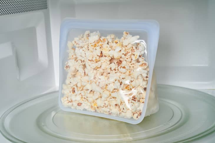 popcorn in a plastic tray sits in the microwave