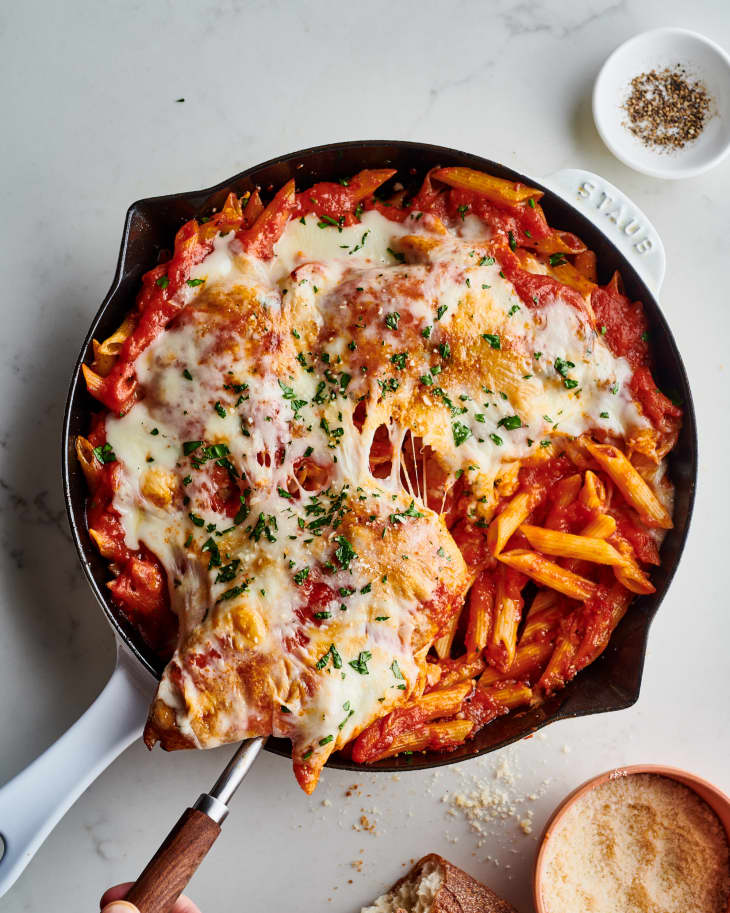 chicken parm sits in a cast iron skillet