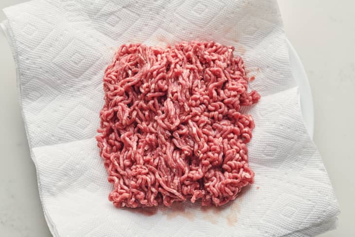 ground beef sits on a paper towel