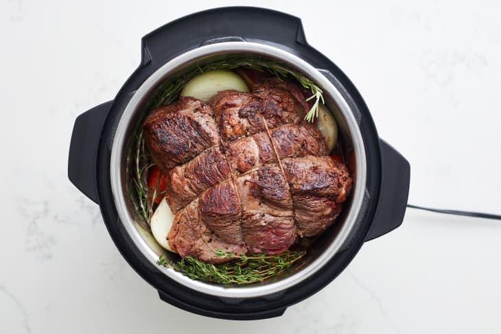 beef sits on top of vegetables, and tied in an instant pot