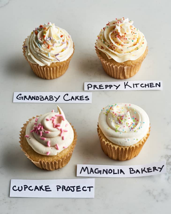 cupcakes on table with labels of whos recipe they are