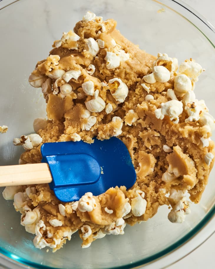 popcorn being poured into dough