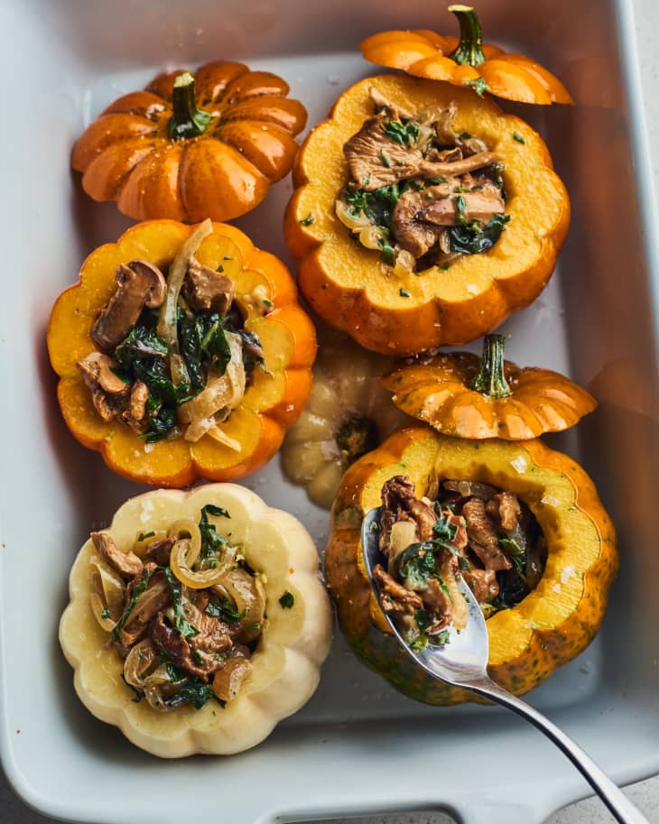 someone pulling stuffing out of mini pumpkin