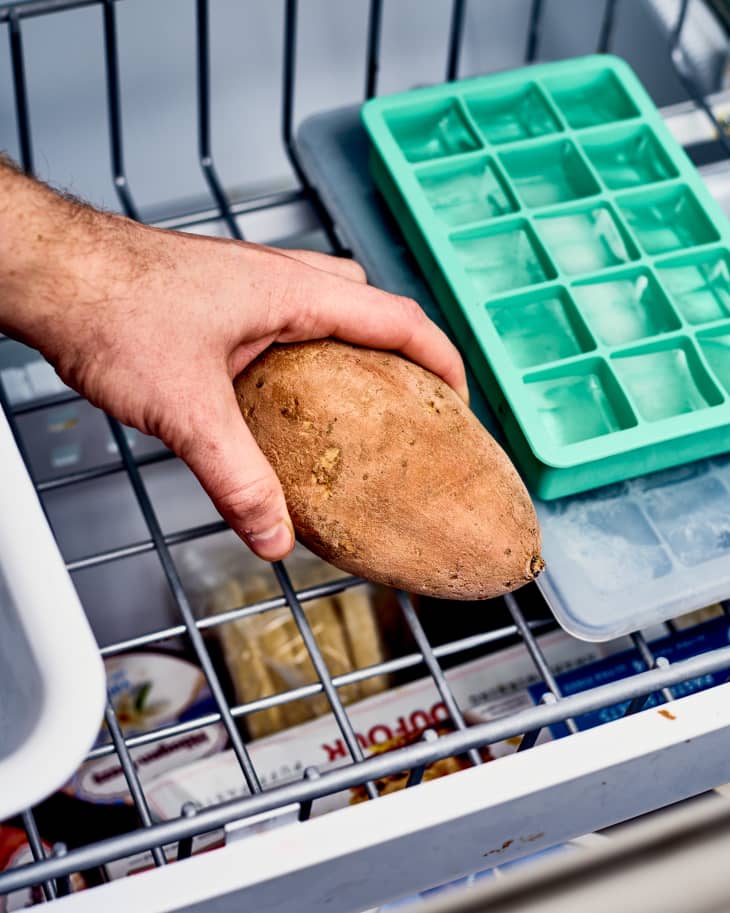 a frozen sweet potato being tasken out of a freezer