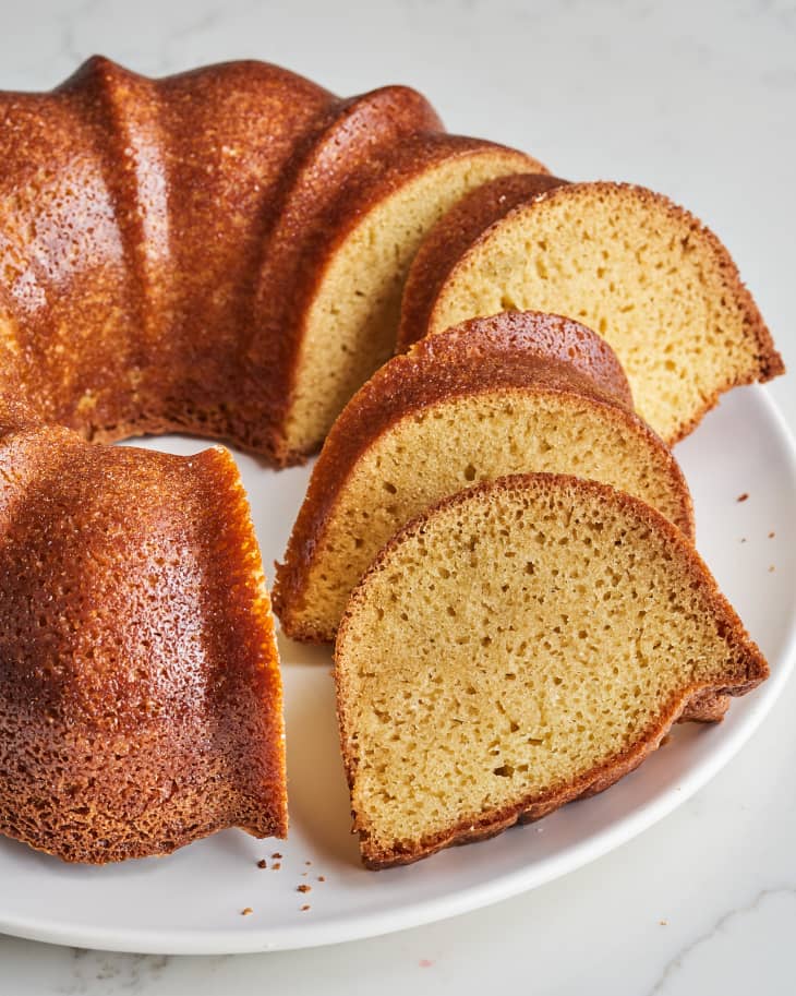 pound cake on a plate with some slices out