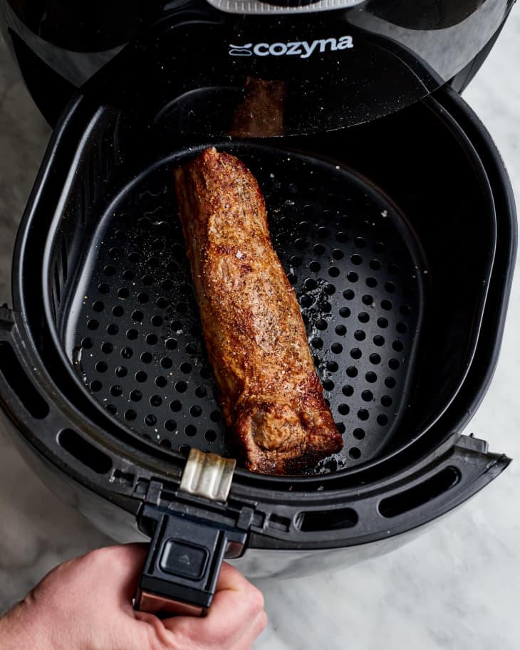 a pork loing coming out of an air fryer