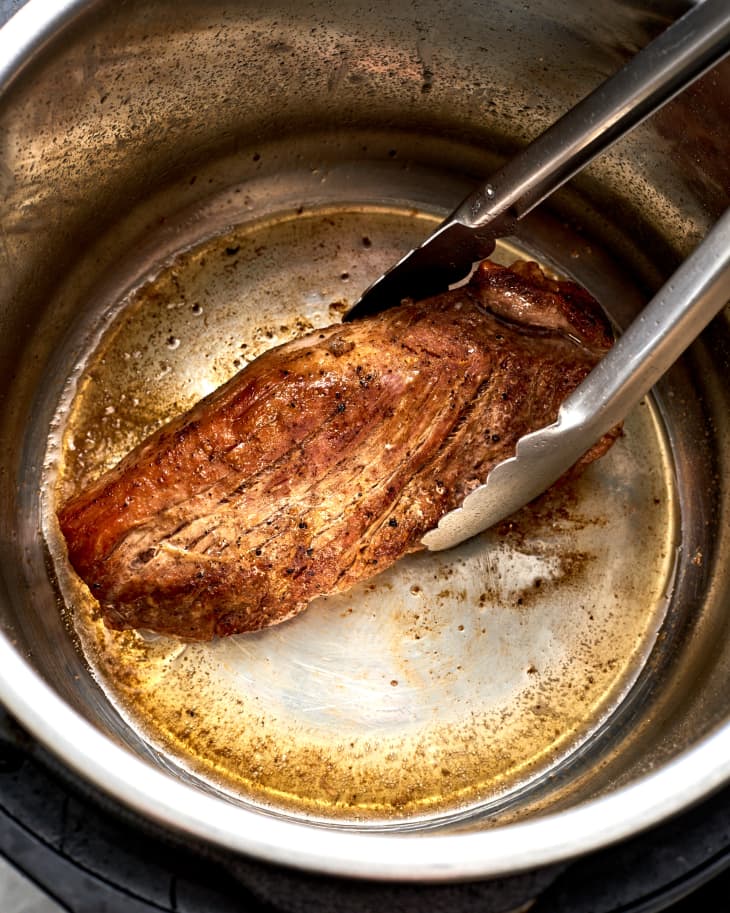a pork loin searing in an instant pot
