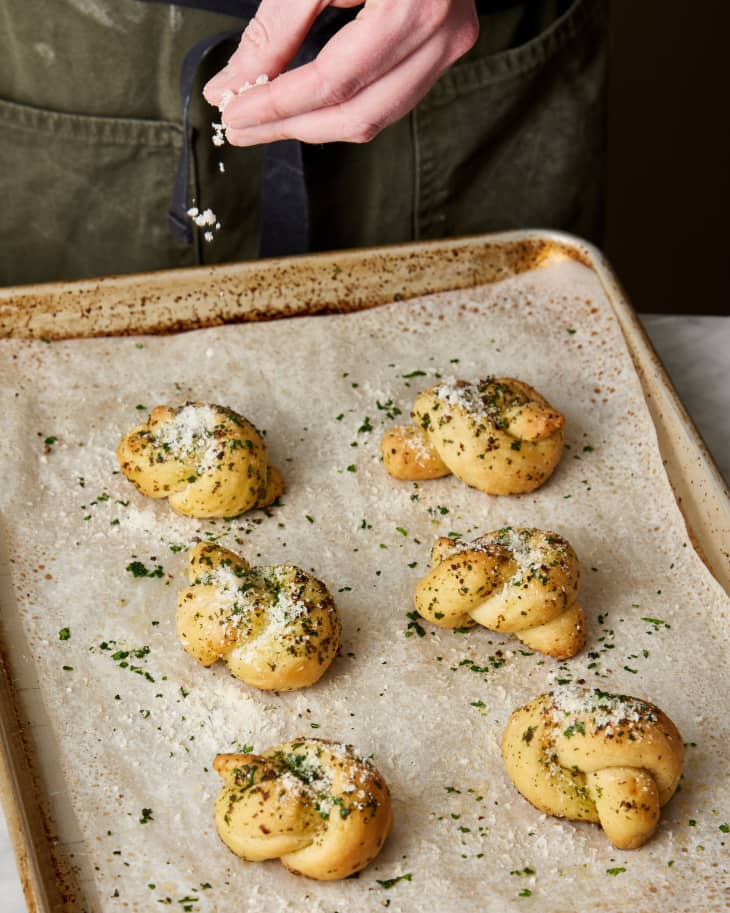 garlic knots finished on parchment paper