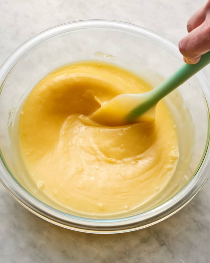 lemon curd being stirred in a microwave safe bowl