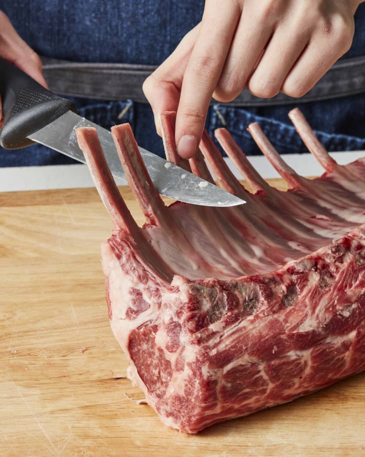 lamb chops being slice with a knife