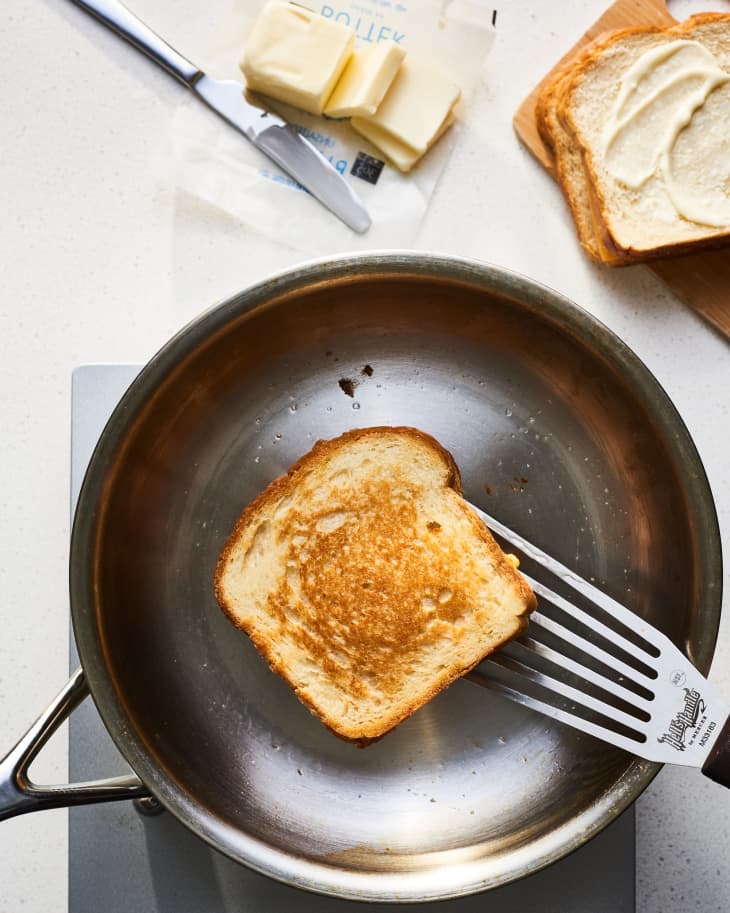 grilled cheese being cooked in butter